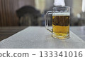 Refreshing mug of beer on a table in a cozy pub setting. Horizontal banner. Copy space. Free space for text. International beer day 133341016