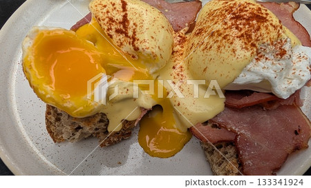 Egg benedicts with running yolk on the toast and bacon in Antwerp 133341924