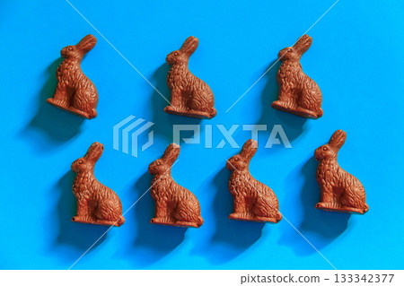 Easter chocolate bunnies on blue background. Top view Easter chocolate bunnies on blue background. Top view 133342377