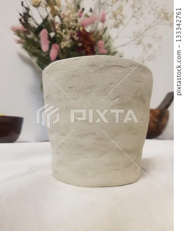 Textured Clay Pot with Dried Flowers Background Textured Clay Pot with Dried Flowers Background 133342761