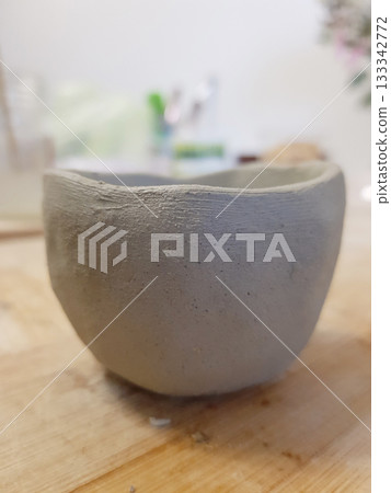 Rustic Clay Bowl: Handmade Pottery Art on Wood Rustic Clay Bowl: Handmade Pottery Art on Wood 133342772