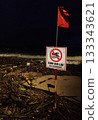 Rainy season storm damage on Nha Trang beach with “No Swimming” warning sign 133343621