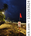 Rainy season storm damage on Nha Trang beach with “No Swimming” warning sign 133343624