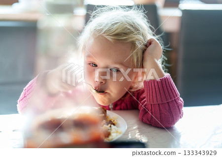 little girl eating pizza in the cafe little girl eating pizza in the cafe 133343929