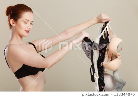 woman choosing bras to wear 133344070