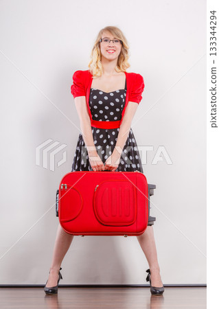 Elegant fashion woman with red suitcase Elegant fashion woman with red suitcase 133344294