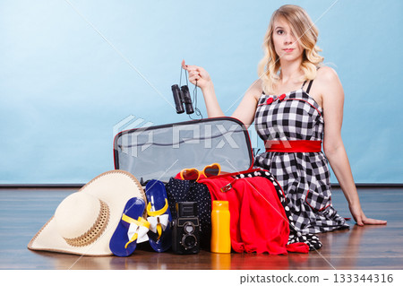 Young woman packing suitcase 133344316