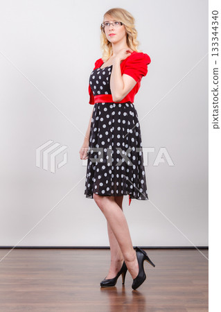 Woman wearing fashion polka dots dress 133344340