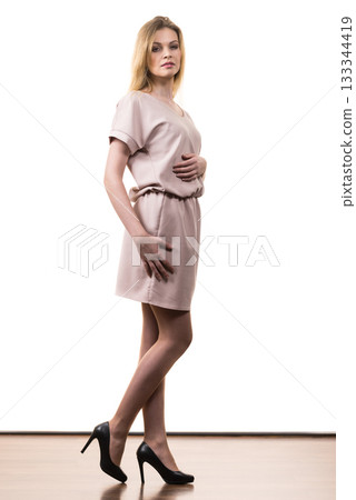 Female wearing casual pink tunic dress 133344419