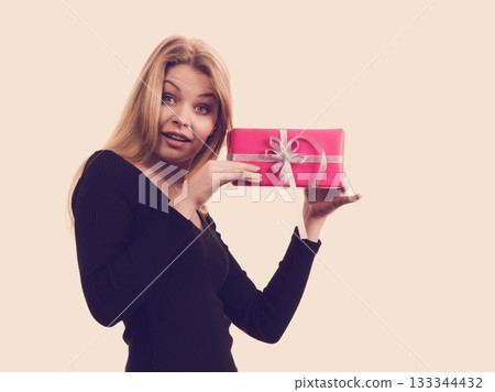 Surprised girl with pink gift box 133344432