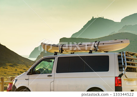 Canoe on roof top of car against mountain 133344522