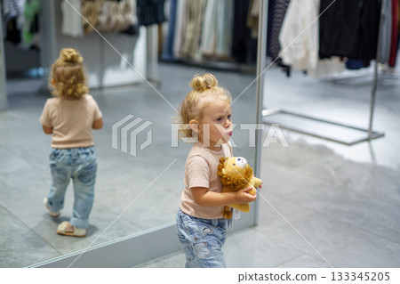 mother and daughter picking apples in shop mother and daughter picking apples in shop 133345205