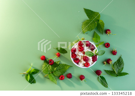 Homemade cottage cheese with raspberries and greens in a cup Homemade cottage cheese with raspberries and greens in a cup 133345218