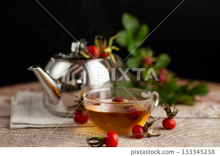 hot medicinal tea with rose hips in a cup on the table hot medicinal tea with rose hips in a cup on the table 133345238