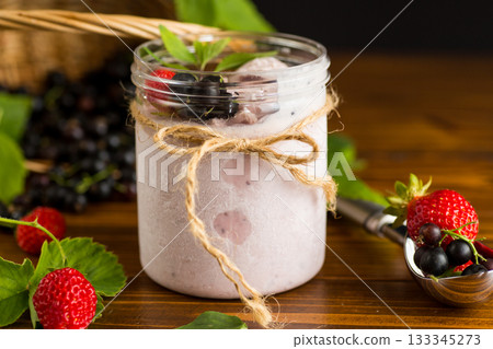 Homemade cold berry ice cream on wooden background Homemade cold berry ice cream on wooden background 133345273