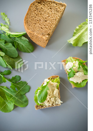Homemade rye bread with herring paste and arugula 133345286
