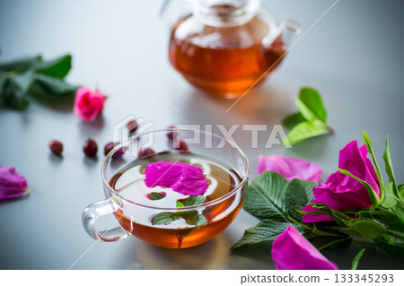 Top view of brewed rosehip tea with mint in glassware 133345293