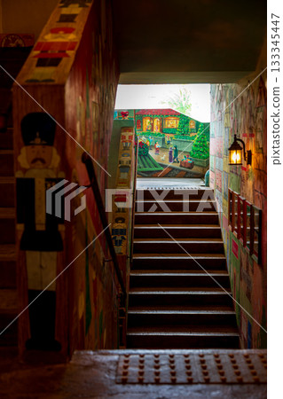 A whimsical nutcracker painting and a Christmas-themed staircase space 133345447