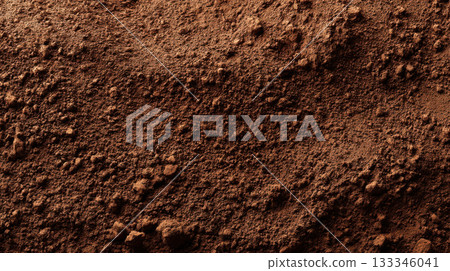 Rich brown clay surface with fine grain texture, earthy natural soil close up 133346041