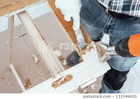 Carpenter at work, restoring an old wooden window. Carpentry. 133346420