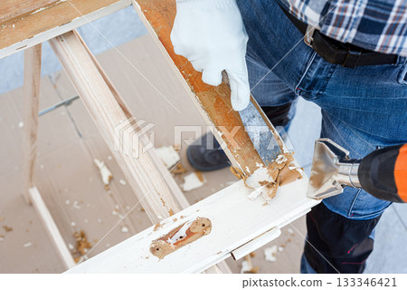 Carpenter at work, restoring an old wooden window. Carpentry. Carpenter at work, restoring an old wooden window. Carpentry. 133346421