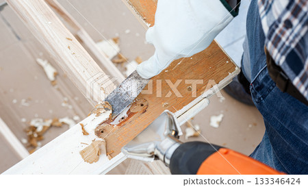 Carpenter at work, restoring an old wooden window. Carpentry. Carpenter at work, restoring an old wooden window. Carpentry. 133346424