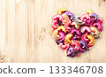 Horizontal banner with Heart formed from uncooked multi-colored pasta on wood texture. Italian food, cuisine, dietary choices, food and love concept. Dried pasta in heart shape. Copy space for text 133346708