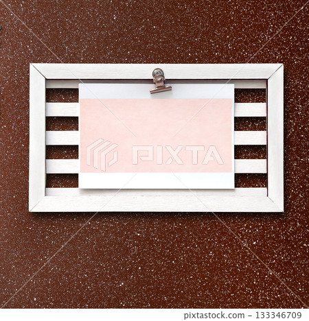 Retro wooden frame with blank paper sheet on stucco wall. Vintage style mood board layout. Vintage wooden empty picture frame on brown wall. Copy space for text Retro wooden frame with blank paper sheet on stucco wall. Vintage style mood board layout. Vintage wooden empty picture frame on brown wall. Copy space for text 133346709