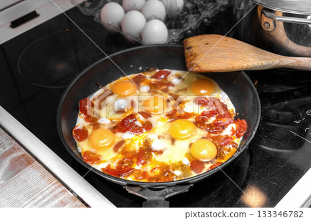 Rustic eggs with tomatoes cooking Rustic eggs with tomatoes cooking 133346782