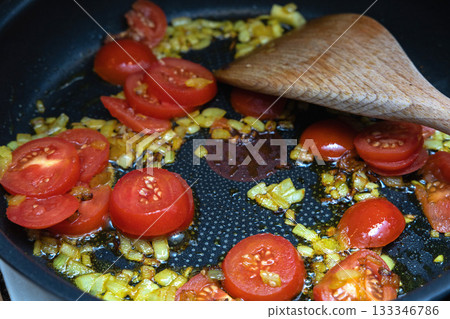 Tomato and onion vegetable stir fry in pan. Tomato and onion vegetable stir fry in pan. 133346786