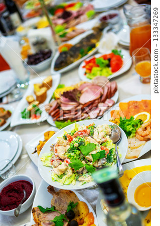 A Colorful Spread of Delicious Dishes at a Festive Gathering in a Restaurant. A Colorful Spread of Delicious Dishes at a Festive Gathering in a Restaurant. 133347269