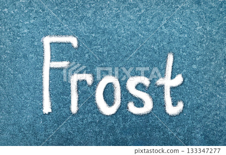 Frost Written in White on a Blue Background, Showcasing the Beauty of Winter's Touch on Surfaces 133347277
