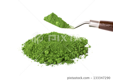 Chrome Green, Green Powder and Trowel on a White Surface Capturing the Essence of Natural Ingredients 133347290