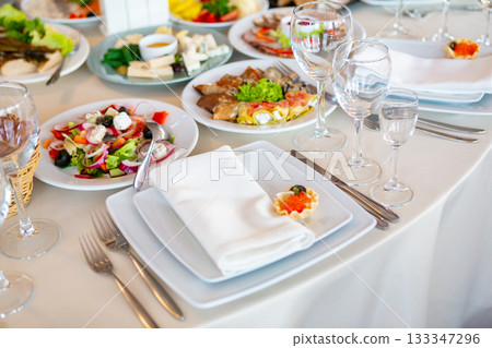 Elegant Dining Setup With Assorted Dishes at a Restaurant During Daytime Gathering 133347296