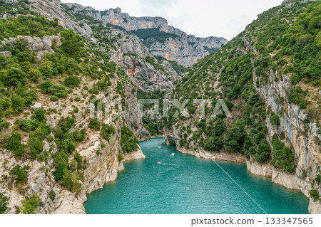 Tourists enjoying turquoise waters of the Verdon River in France, paddling pedal boats and kayaks on a sunny day 133347565