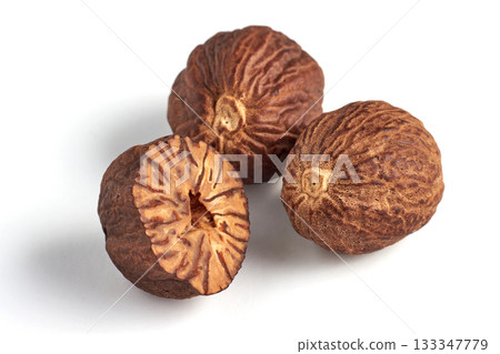 three dried nutmegs isolated on white background. three dried nutmegs isolated on white background. 133347779