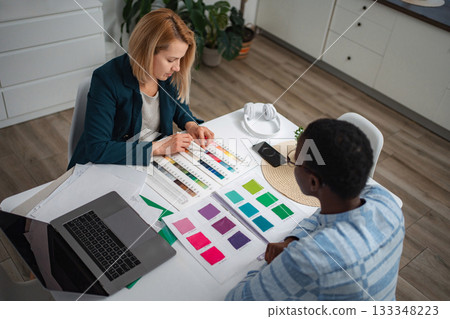 Women collaborating on interior design choosing color swatches 133348223
