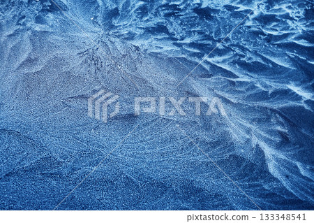 Frosty Patterns. Close-up of intricate frost designs on a blue surface, Frosty Patterns. Close-up of intricate frost designs on a blue surface, 133348541