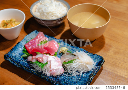 A home-style dinner of tuna, horse mackerel, and squid sashimi with miso soup and rice A home-style dinner of tuna, horse mackerel, and squid sashimi with miso soup and rice 133348546