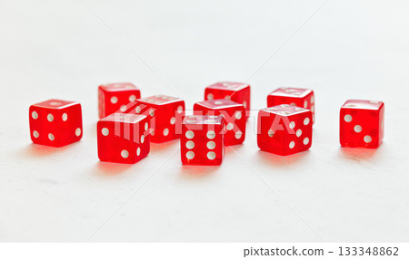 Ten red translucent craps dices on white board showing different numbers Ten red translucent craps dices on white board showing different numbers 133348862