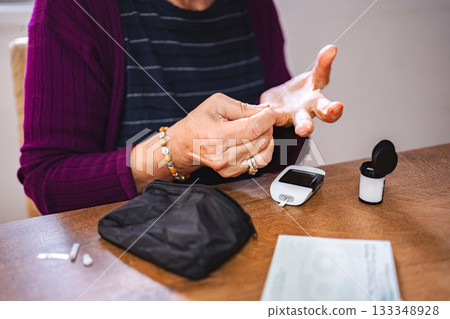 Checking blood sugar levels at home during morning routine Checking blood sugar levels at home during morning routine 133348928