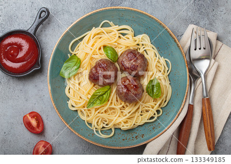 Delicious spaghetti with meatballs on plate, tomato sauce and basil on gray background top view 133349185