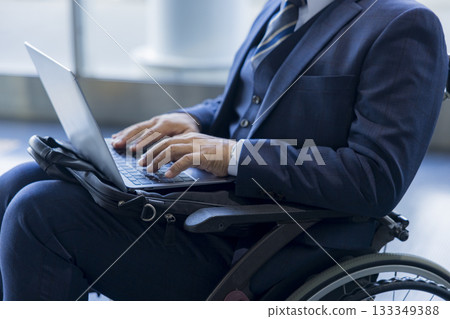 A man in a suit sitting in a wheelchair A man in a suit sitting in a wheelchair 133349388