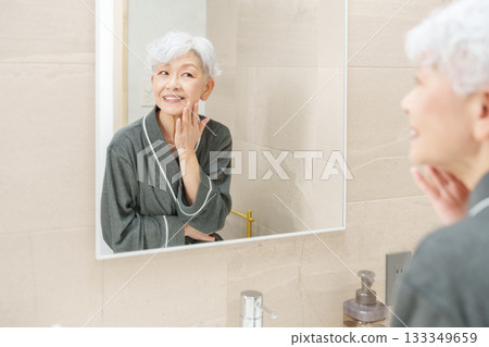 Senior woman doing skin care Senior woman doing skin care 133349659