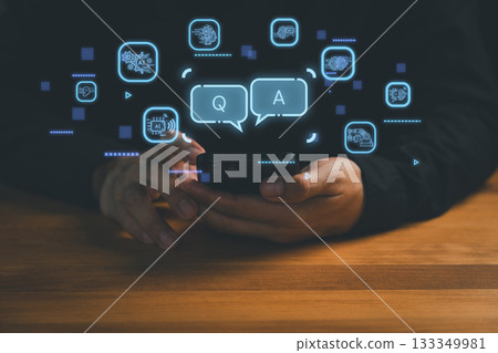 Close-up of hands holding smartphone with digital Q&A chat icons and AI technology symbol, representing chatbot conversation, virtual assistant, customer support, and artificial intelligence solution. Close-up of hands holding smartphone with digital Q&A chat icons and AI technology symbol, representing chatbot conversation, virtual assistant, customer support, and artificial intelligence solution. 133349981
