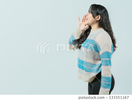 Young asian woman shouting an announcement. Beautiful asian girl shouting a promotion isolated Young asian woman shouting an announcement. Beautiful asian girl shouting a promotion isolated 133351167