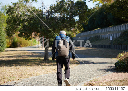 Senior man walking in the park on an autumn morning Senior man walking in the park on an autumn morning 133351467