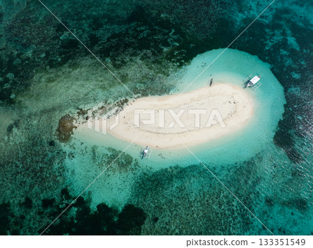 View from above of sandbar with pale sand and turquoise lagoon water over coral reef. Naked Island. Siargao, Philippines. 133351549