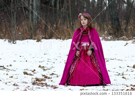 Girl in a Halloween costume of a princess in woods, long red dress. 133351818