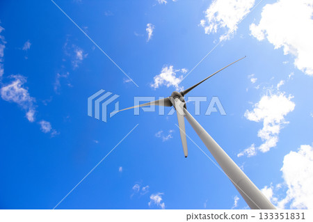 Windmill with huge blades in the sky, sustainable energy source Windmill with huge blades in the sky, sustainable energy source 133351831
